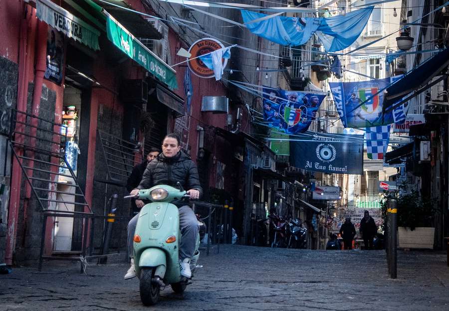 Photos of Napoli's players, flags and scarves decorate a street in the Quartieri Spagnoli district of Naples