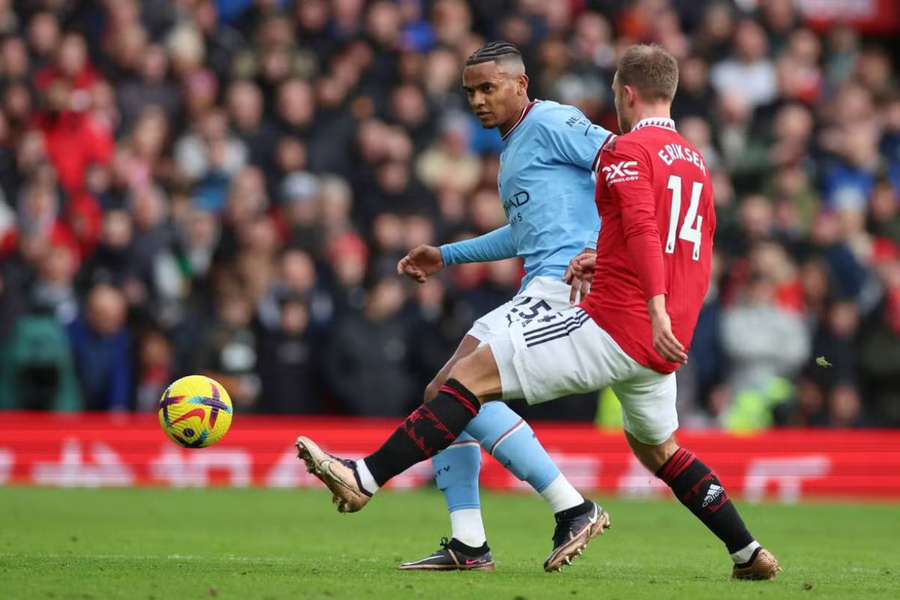 Man City's Manuel Akanji duels with Man Utd's Christian Eriksen