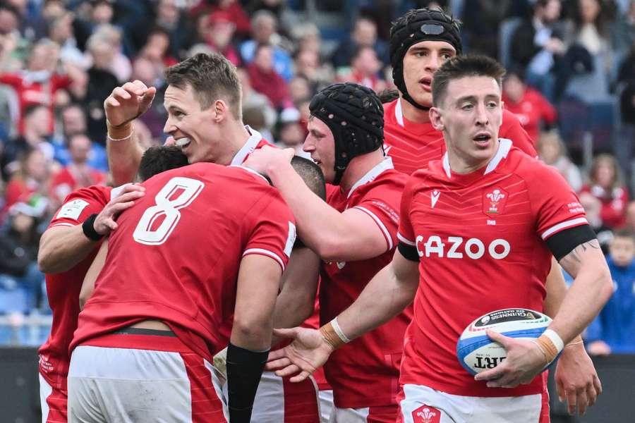 Wales' flanker Toby Faletau (Front L) celebrates with Wales' full-back Liam Williams (Rear L) after scoring his side's fourth try