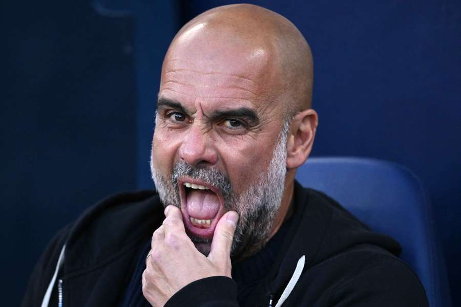 Manchester City head Coach Pep Guardiola reacts on the bench