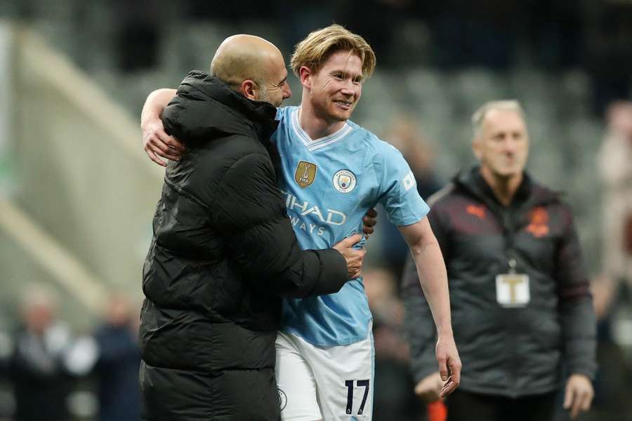 Guardiola celebrates with Kevin De Bruyne after the game