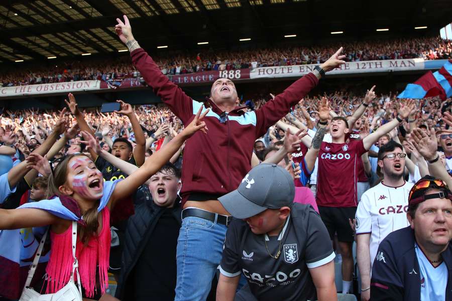 Happy Aston Villa fans celebrate after the English Premier League football match between Aston Villa and Brighton