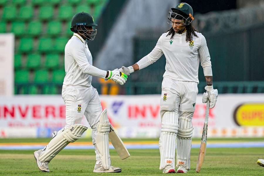 Tony de Zorzi (R) and Senuran Muthusamy shake hands at the end of play