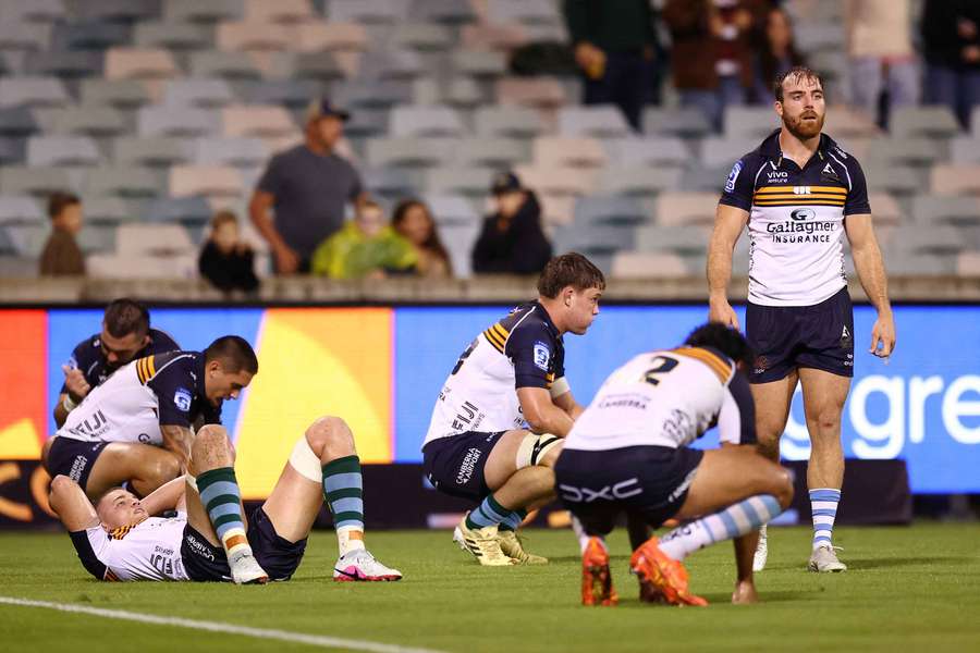 Dejected Brumbies players lament their narrow defeat to the Reds on Saturday night.