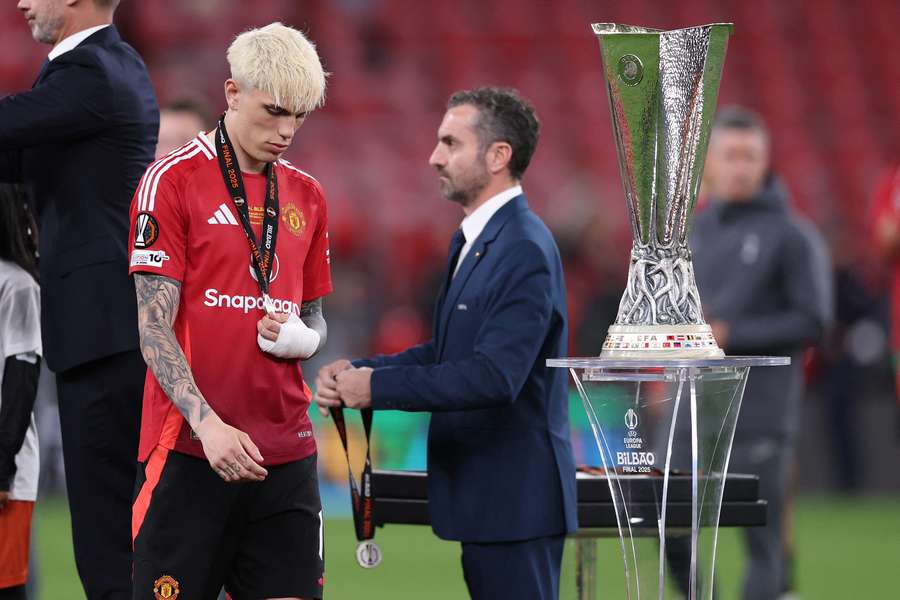 Alejandro Garnacho of Manchester United walks past the UEFA Europa League trophy