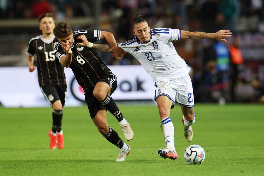 Greece's Konstantinos Tsimikas battles with Germany's Tom Bischof Greece's Konstantinos Tsimikas battles with Germany's Tom Bischof