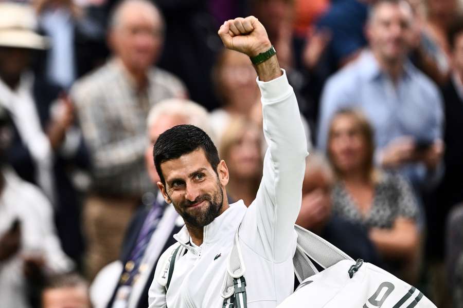 Novak Djokovic reacts as he leaves the court after winning against Jannik Sinner