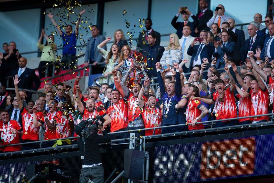 Luton Town celebrate gaining promotion to the Premier league in the Sky Bet Championship Play-Off Final trophy beating Coventry City 6-5 on penalties