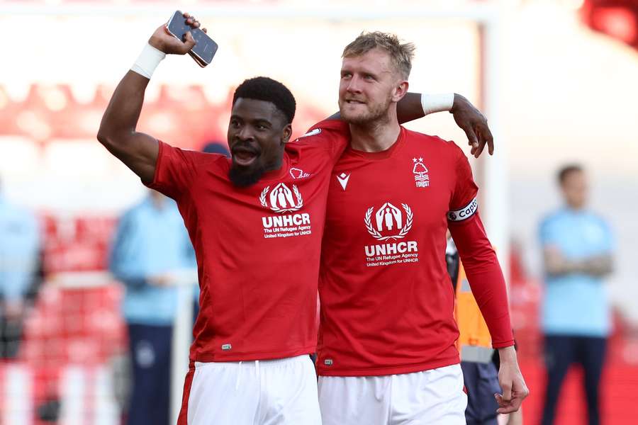 Worrall (R) celebrates Forest's victory alongside Serge Aurier