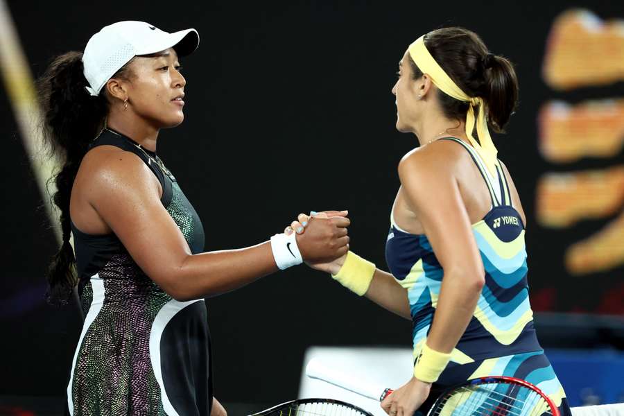 France's Caroline Garcia (R) shakes hands with Japan's Naomi Osaka