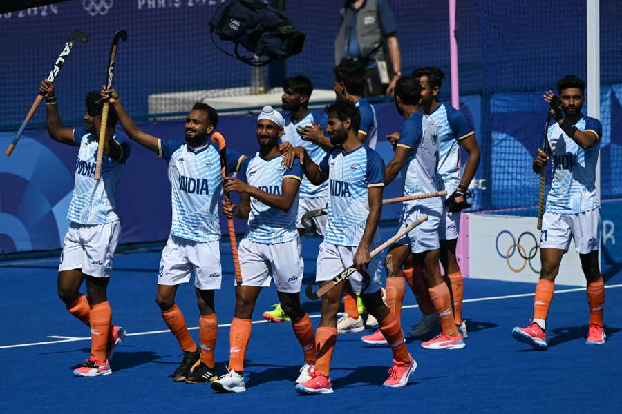 India's players celebrate after winning the bronze medal