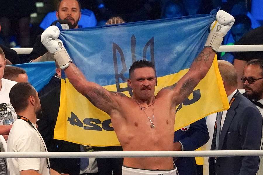 Ukraine’s reigning world heavyweight champion Oleksandr Usyk celebrates winning his fight against challenger Daniel Dubois