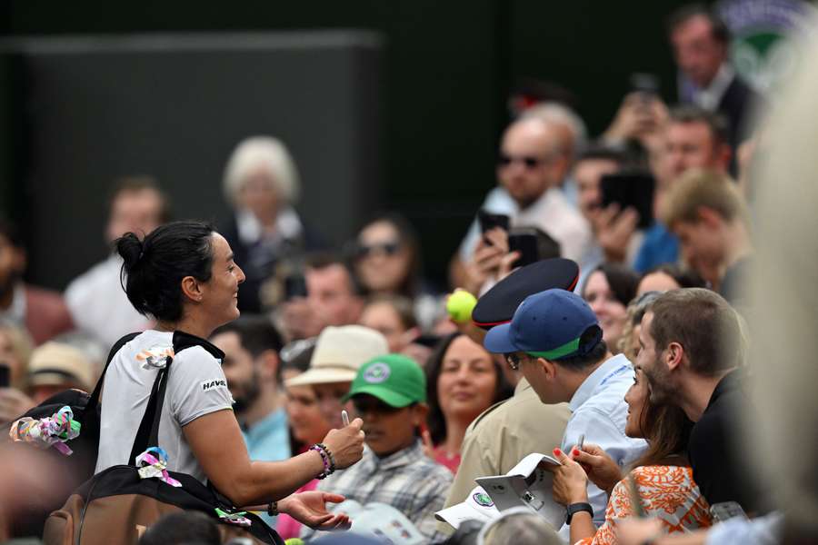 Ons Jabeur signs autographs after her win