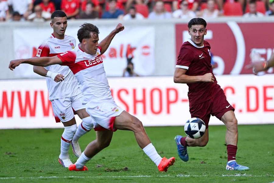 Stuttgart's Christopher Olivier and Nathan Doganay from Kickers Offenbach battele for the ball in friendly Stuttgart's Christopher Olivier and Nathan Doganay from Kickers Offenbach battele for the ball in friendly
