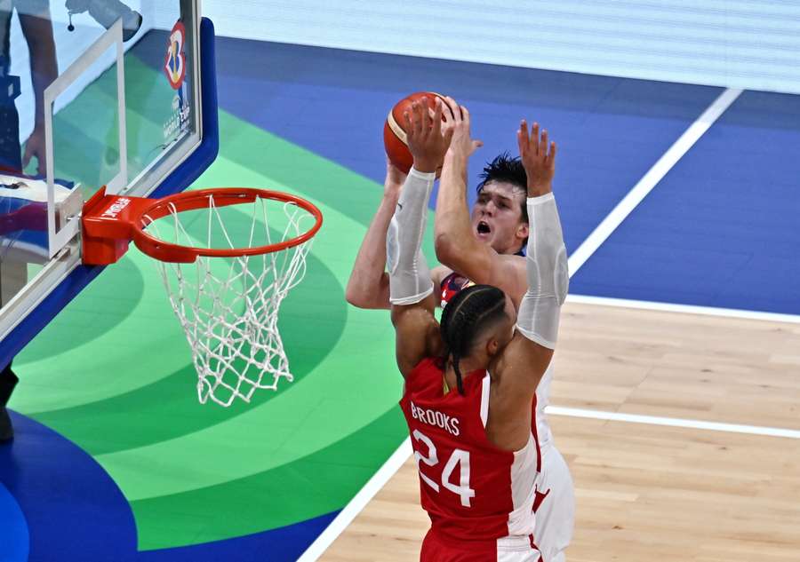 Austin Reaves of the US in action with Canada's Dillon Brooks