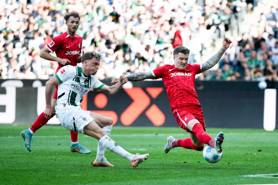 Freiburg's Kubler (right) makes a vital block against Monchengladbach Freiburg's Kubler (right) makes a vital block against Monchengladbach