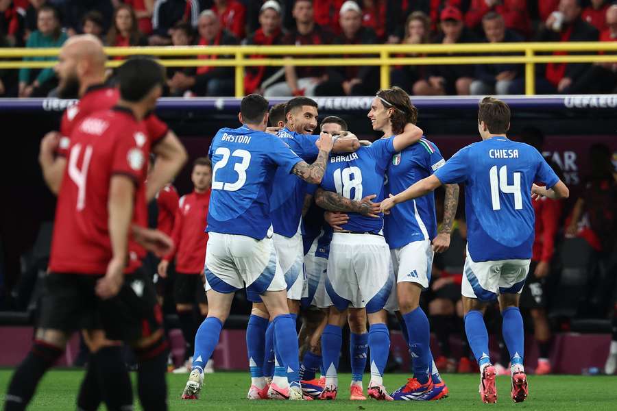 Italy midfielder Nicolo Barella (C) celebrates with teammates after scoring his team's second goal