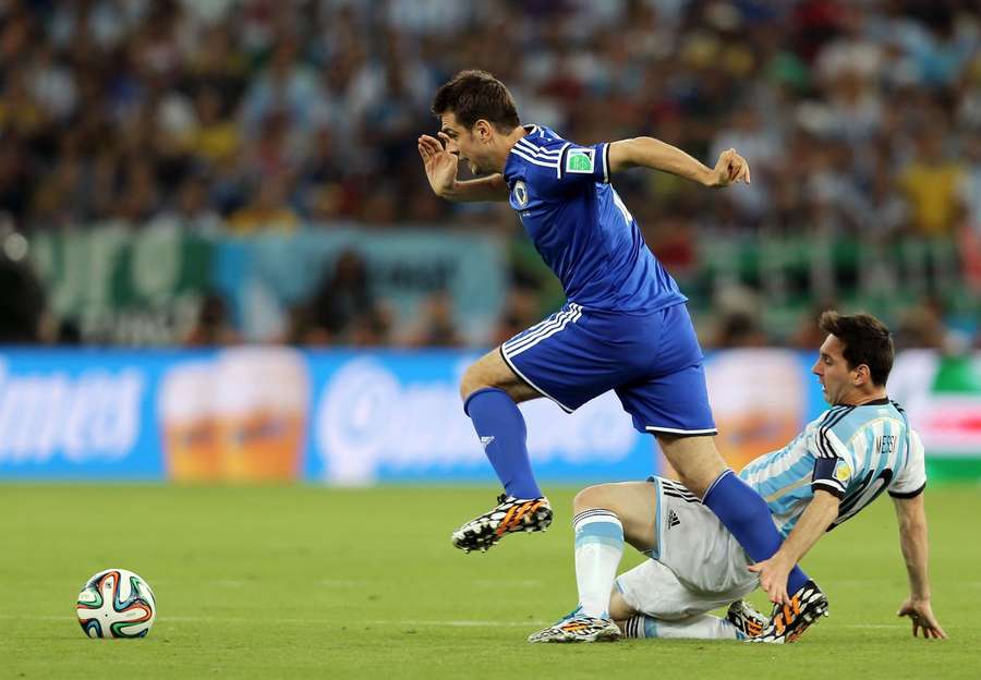 Messi tackling Misimovic at the 2014 World Cup. Messi tackling Misimovic at the 2014 World Cup.