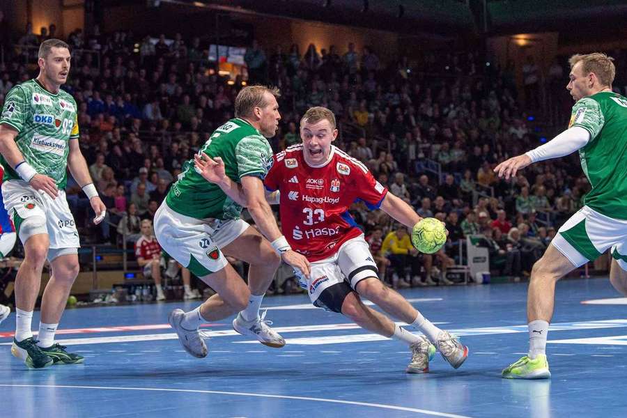 Hamburg's Moritz Sauter tries to break through watched by Fuchse's Mijajlo Marsenic,  Max Darj and Mathias Gidsel Hamburg's Moritz Sauter tries to break through watched by Fuchse's Mijajlo Marsenic,  Max Darj and Mathias Gidsel