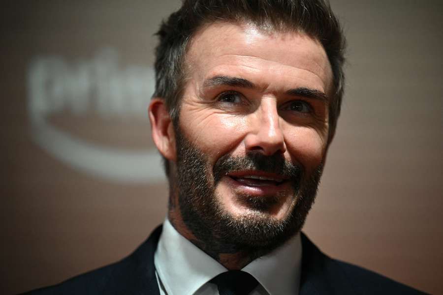 Former Manchester United footballer David Beckham reacts on the red carpet upon arrival to attend the world premiere of the documentary '99'