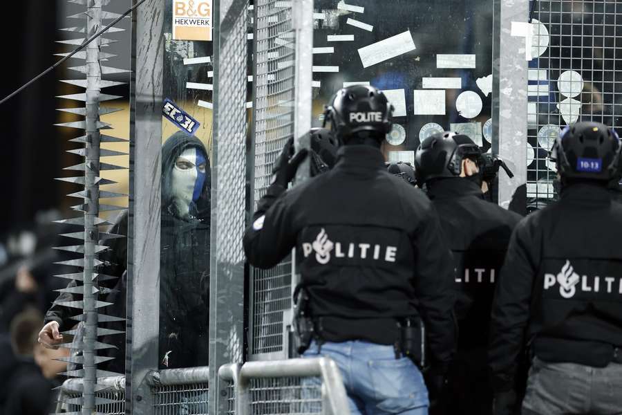 A Genk fan provokes Dutch riot police ahead of the game against FC Utrecht