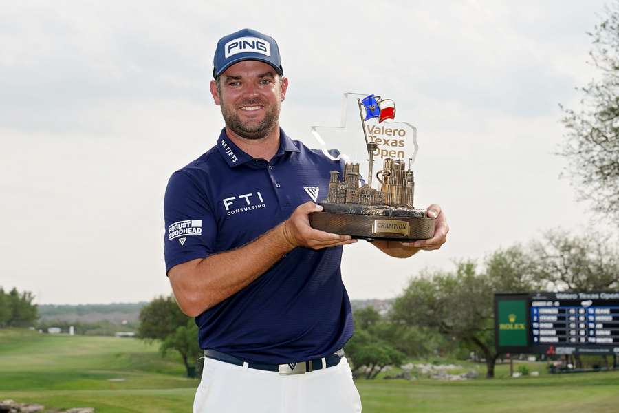 Corey Conners of Canada poses with the trophy