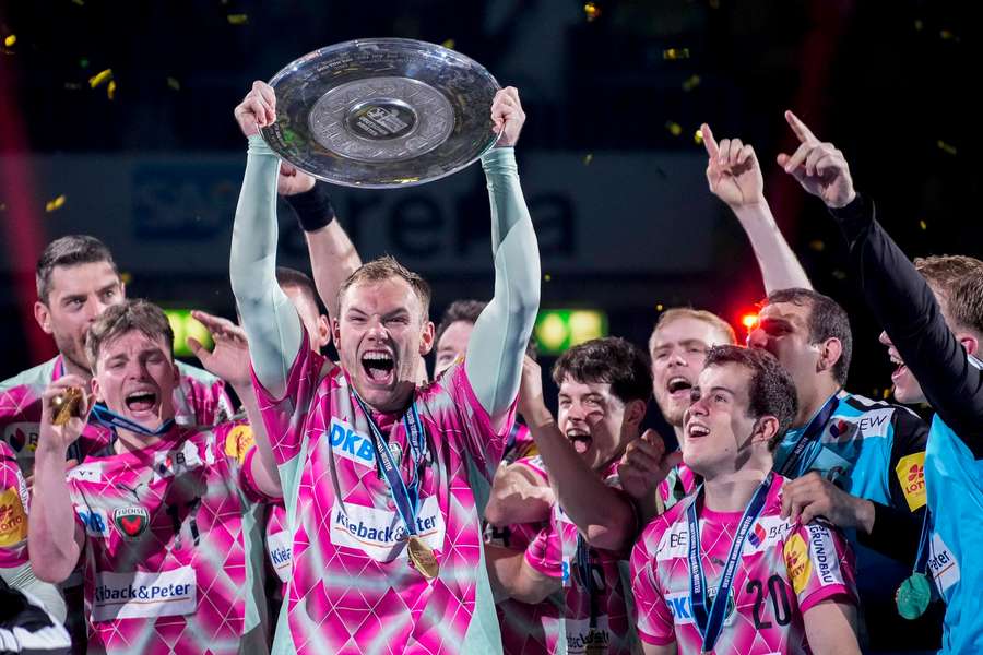 Mathias Gidsel lifts the Championship trophy after the end of last season