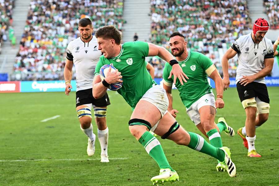 Ireland's lock Joe McCarthy runs in for a try during their match against Romania