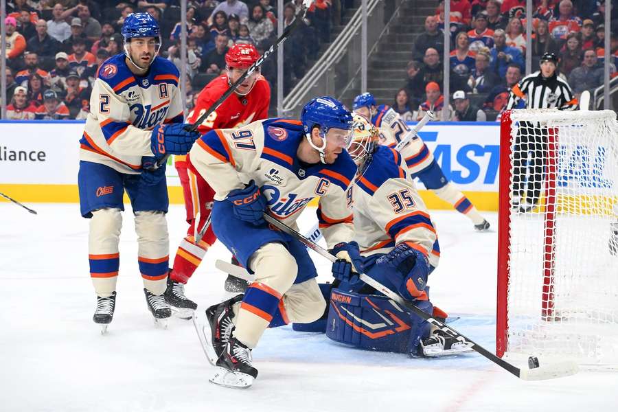 Connor McDavid handles the puck during a game against the Calgary Flames (2026) Connor McDavid handles the puck during a game against the Calgary Flames (2026)