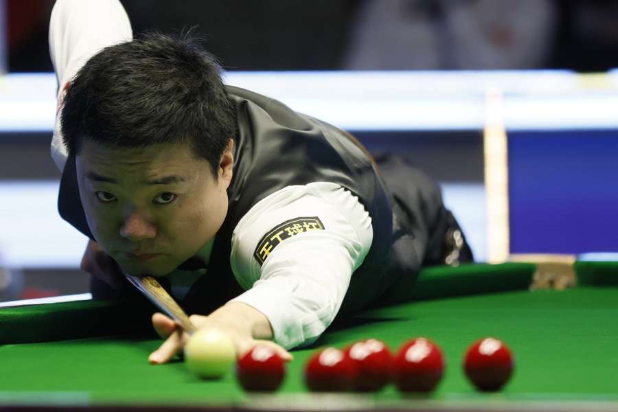 Junhui Ding takes a shot in his semi-final clash with Judd Trump on Saturday