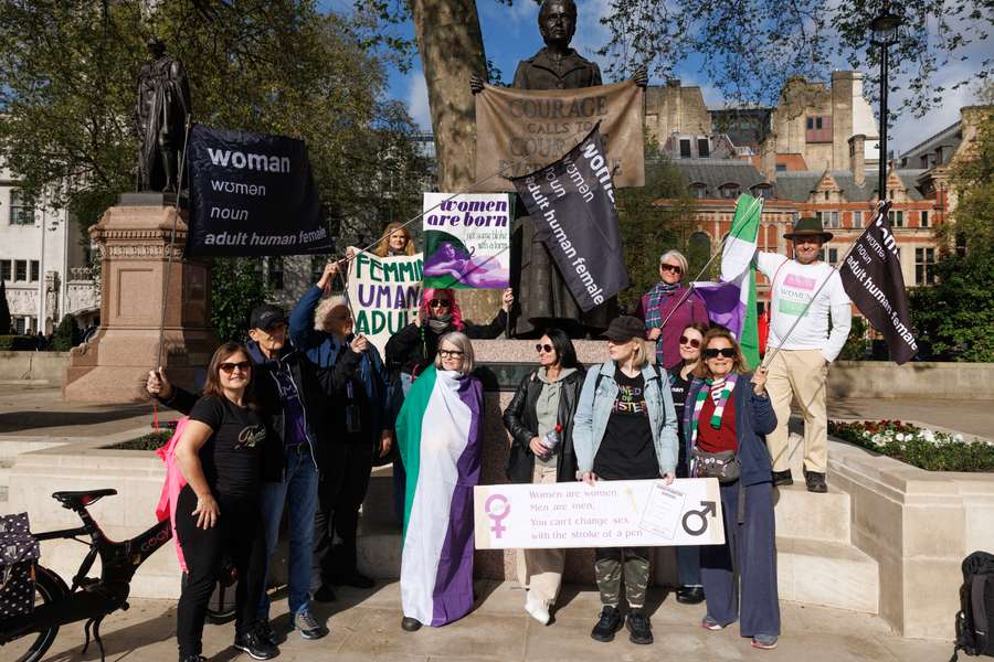 Campaigners stand next to the suffrage activist Dame Millicent Fawcett in Parliament Square