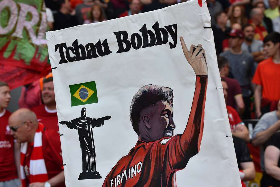 Tribute banners to Liverpool's Brazilian striker Roberto Firmino and are pictured ahead of the English Premier League football match between Liverpool and Aston Villa