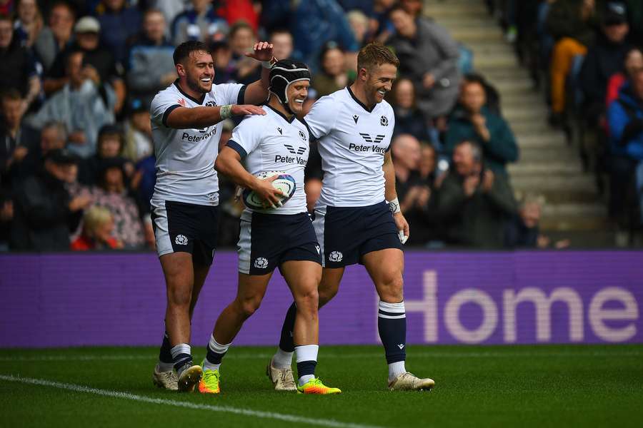 Scotland wing Darcy Graham (C) celebrates after scoring the team's first try