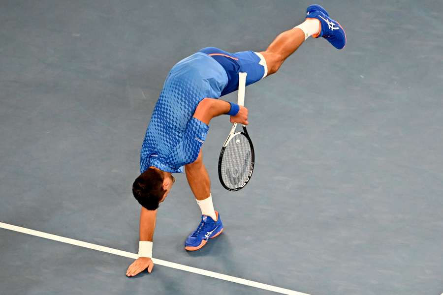 Djokovic stretches during his semi-final against Tommy Paul