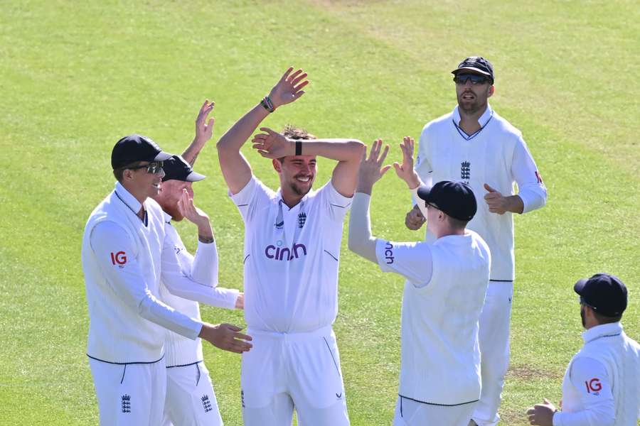 England's Josh Tongue (C) celebrates with teammates