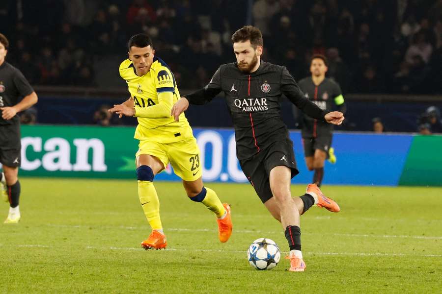PSG's Khvicha Kvaratskhelia battles Tottenham's Pedro Porro 