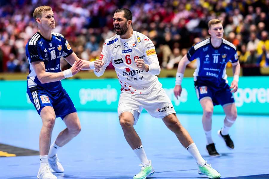 Ellidi Vidarsson of Iceland looks dejected and Mario Sostaric of Croatia celebrates during the game