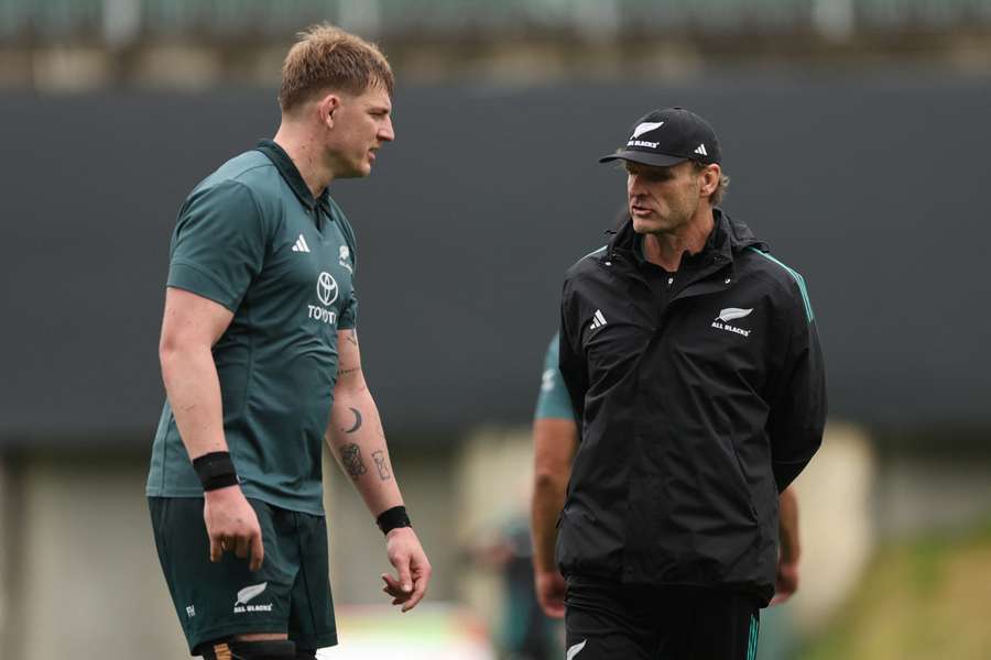 All Blacks coach Scott Robertson chats with Fabian Holland at a training session this week.