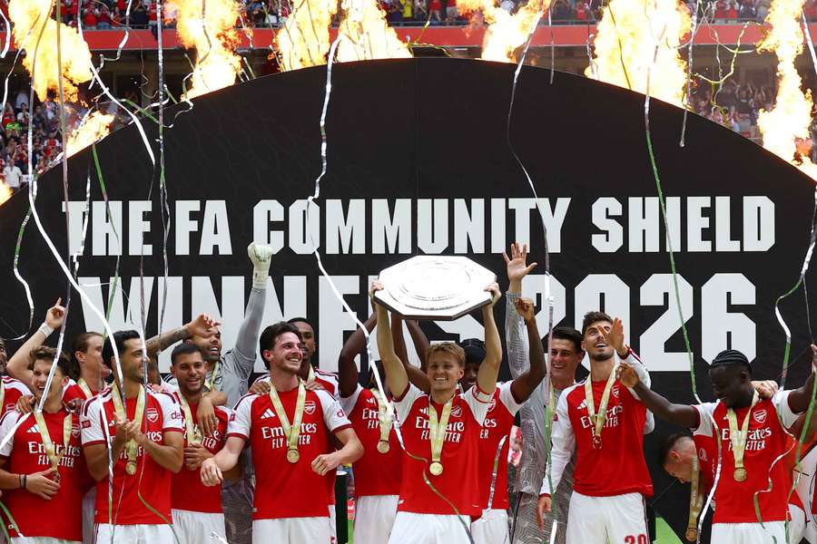 Arsenal's Martin Odegaard (centre) lifts the trophy Arsenal's Martin Odegaard (centre) lifts the trophy