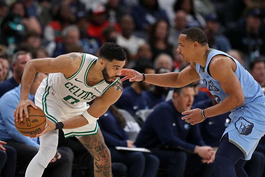 Celtics guard Jayson Tatum (left) being guarded by Desmond Bane (right) 