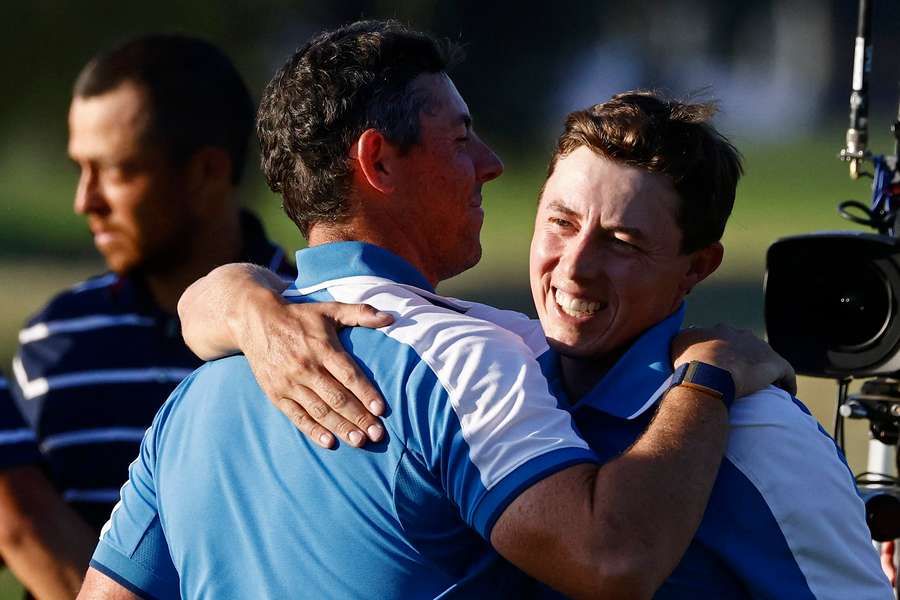 Matt Fitzpatrick and Rory McIlroy embrace after the pair's fourballs victory
