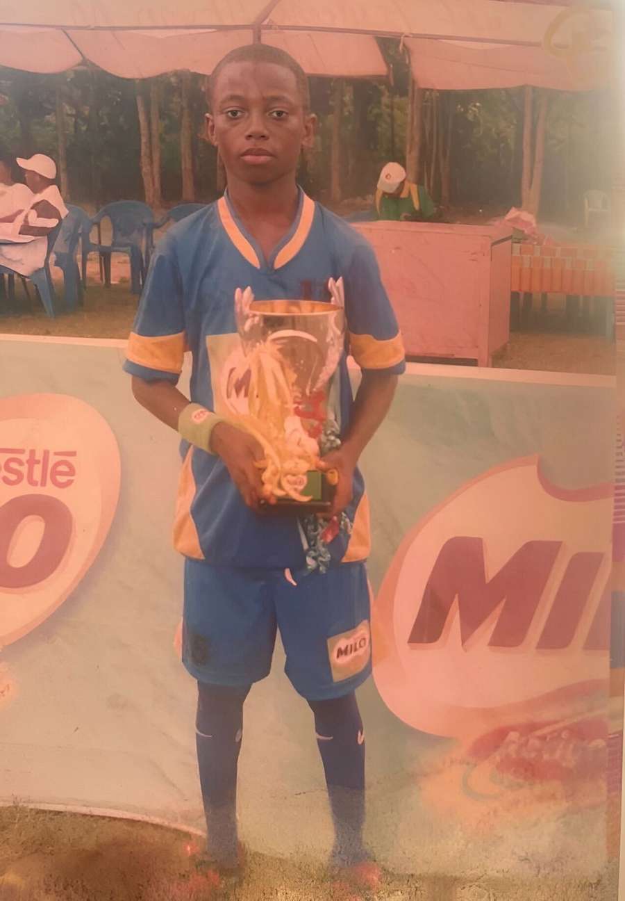 Mensah with the trophy for the Milo Games in 2010. which he won as captain