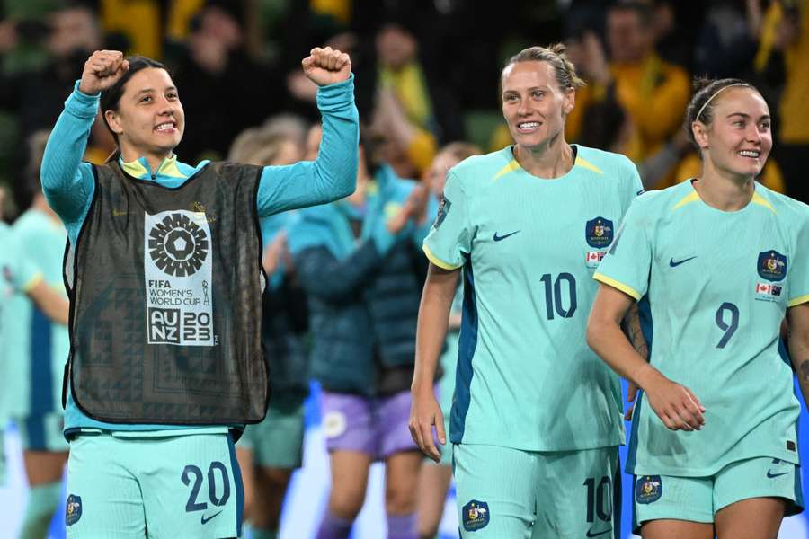 Australia's forward #20 Sam Kerr (L) celebrates with teammates