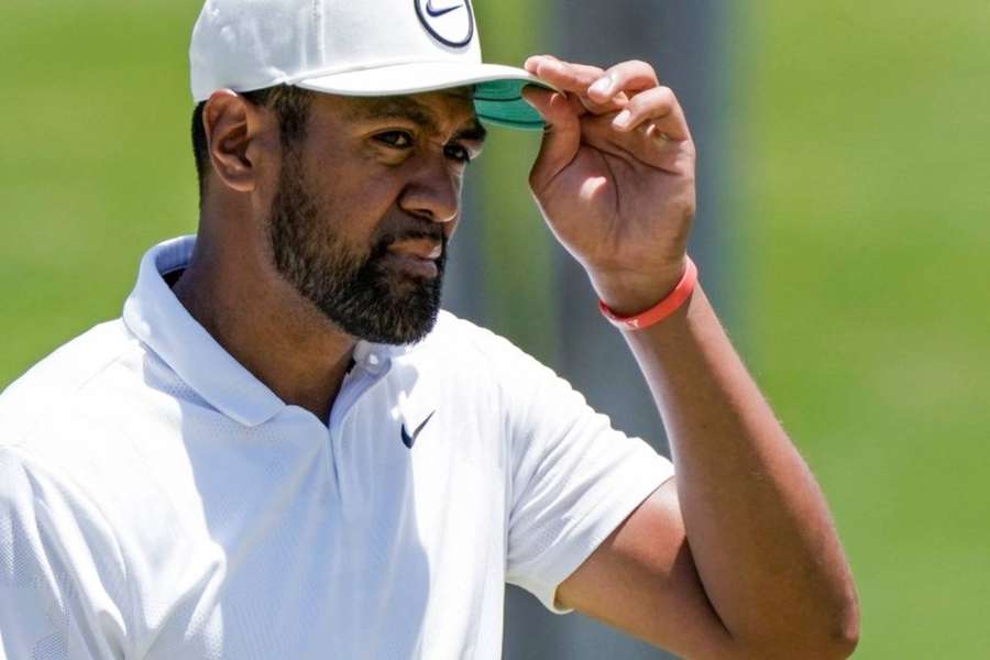 Tony Finau adjusts his cap at the 9th green on the second round