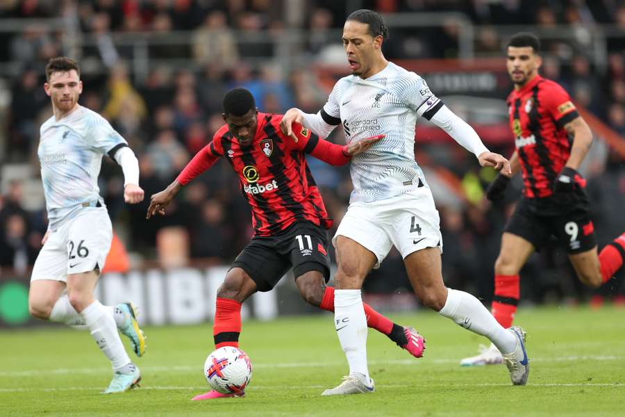 Liverpool's Dutch defender Virgil van Dijk (2R) tackles Bournemouth's Burkinabe striker Dango Ouattara (2L)